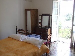Our room at Agriturismo Erba Persa with door to balcony open.