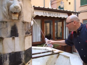 All over Italy you will find public drinking fountains with excellent water. Buy your initial bottle of mineral water, but once empty just fill it for free from the public fountains, which even in warm weather run nice and cool; you’ll even see locals bringing a rolling cart to fill many bottles from these fountains to take home.